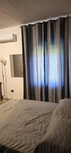 a bedroom with a bed with a black curtain at La Casa di Giò in Taormina