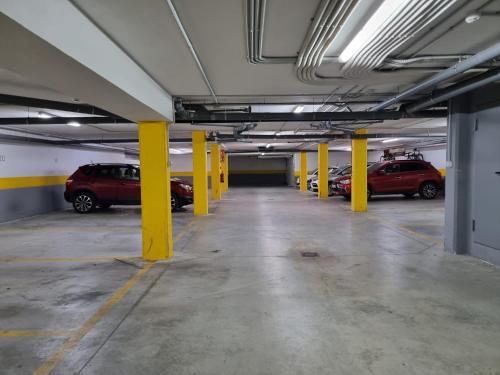 a parking garage with cars parked in it at Residencial Costa Doñana (Sanlucar de Barrameda) in Sanlúcar de Barrameda