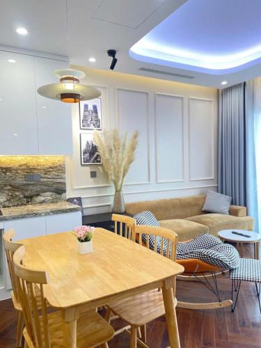 a living room with a table and a couch at LAD Homestay & Apartment Hải Phòng - Diamond Crown Lê Hồng Phong in Ðông Khê