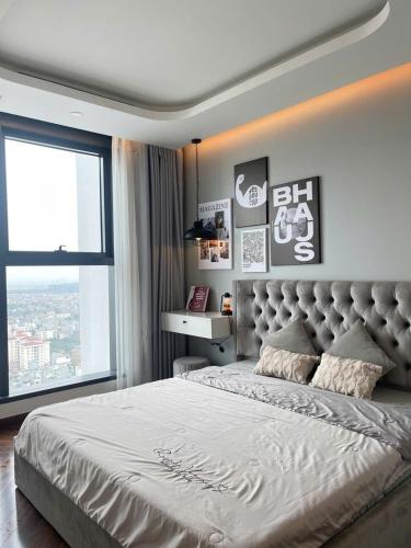a bedroom with a large bed with a large window at LAD Homestay & Apartment Hải Phòng - Diamond Crown Lê Hồng Phong in Ðông Khê