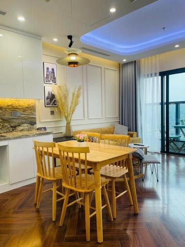 a dining room with a wooden table and chairs at LAD Homestay & Apartment Hải Phòng - Diamond Crown Lê Hồng Phong in Ðông Khê