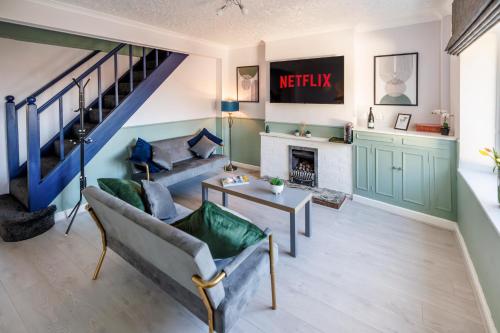 a living room with a couch and a fireplace at Columbia - Sleeps 5, WiFi, Parking, Netflix, Near Observatory in Sutton in Ashfield