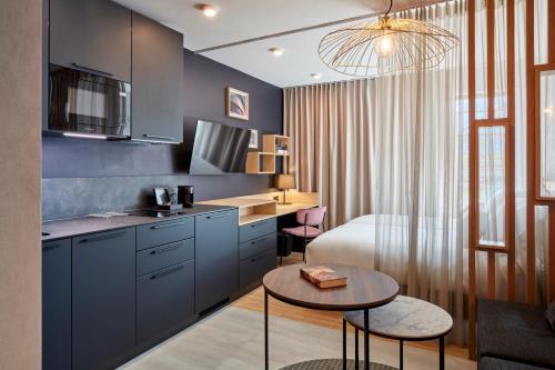 a kitchen with a bed and a table in a room at Aparthotel Adagio London City East in London