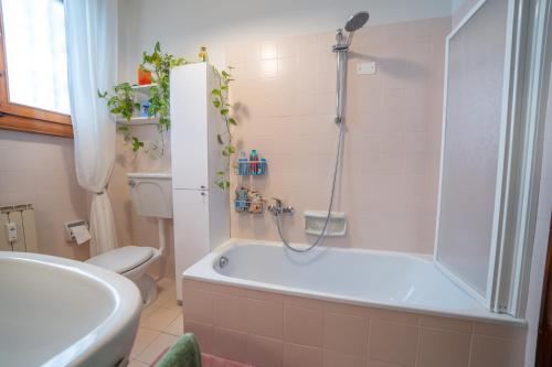 a bathroom with a tub and a toilet and a sink at Da Luigi Pio in Florence