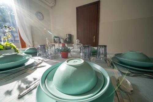 a table with green plates and bowls on it at Da Luigi Pio in Florence