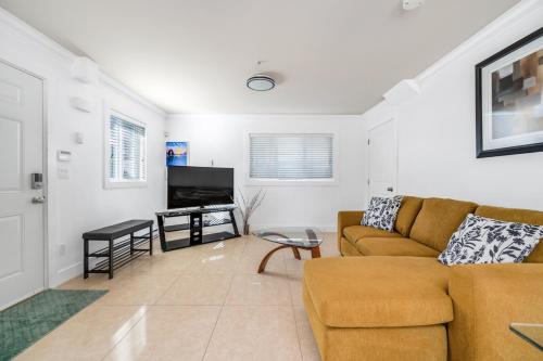 a living room with a couch and a television at Spacious and Modern Comfort Retreat in Heart of Vancouver in Vancouver
