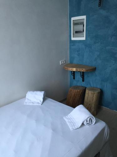 a room with a bed and a table with towels at THE82 HOSTEL Midi in Brussels