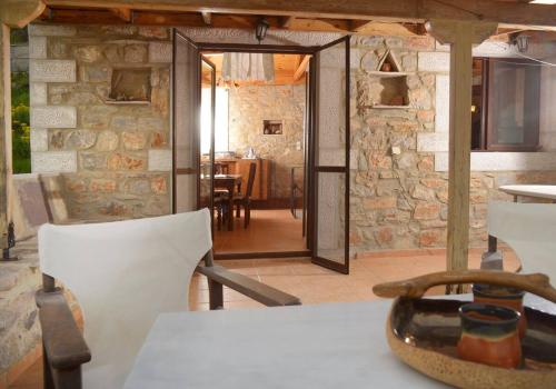 a kitchen with a table and a stone wall at Mani Rock in Limbókhova
