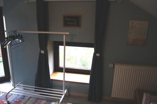 a bedroom with a window and a bed frame and a mirror at Gite 1815 avec sauna privatif in Braine-lʼAlleud