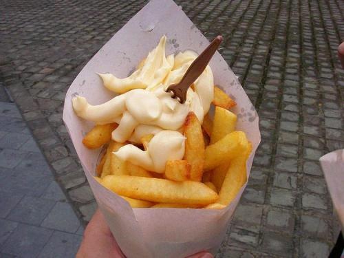 a person holding a container of french fries and ice cream at Gite 1815 avec sauna privatif in Braine-lʼAlleud