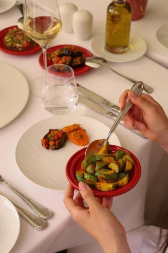 a person eating a bowl of food on a table at Riad Fes - Relais & Châteaux in Fès