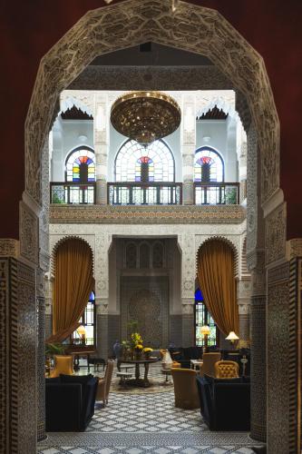 an archway in a building with chairs and tables at Riad Fes - Relais & Châteaux in Fès