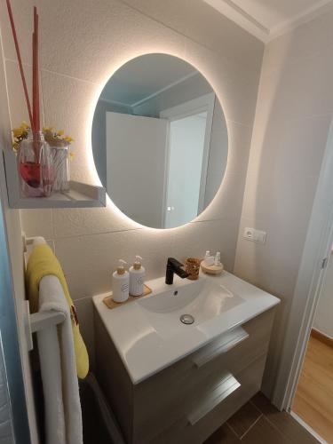 a bathroom with a sink and a mirror at Casa Teo. in Santa Pola