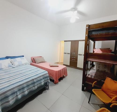 a bedroom with a bed and a bunk bed at CASA - 7 quartos - 10 vagas de garagem in Campo Grande