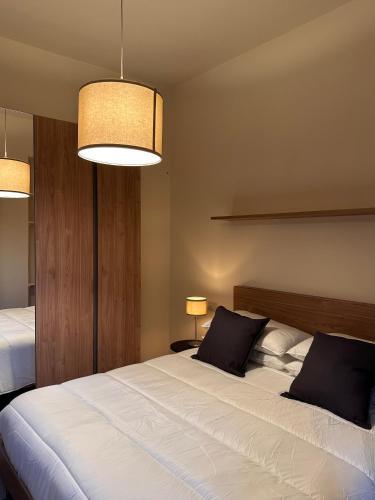 a bedroom with a large white bed with two pillows at Hotel Ristorante San Giuseppe in Cernobbio