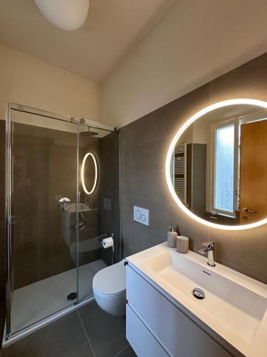 a bathroom with a toilet and a sink and a mirror at Hotel Ristorante San Giuseppe in Cernobbio