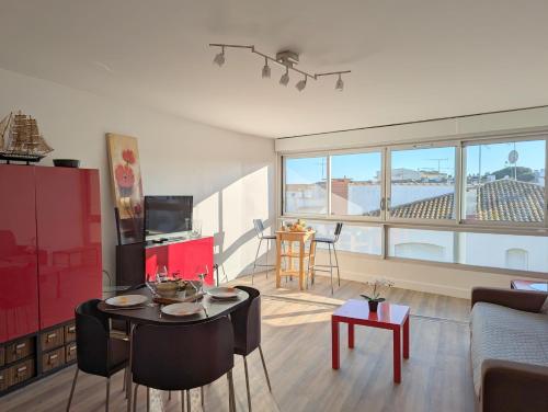 un salon avec une table et des chaises dans une pièce dans l'établissement Sol-y-Days Murènes, Grand studio confortable avec parking, proche du centre ville et de la plage, au Grau-du-Roi