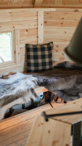 two animals laying on a bed in a cabin at Hotel Waltikka in Valkeakoski