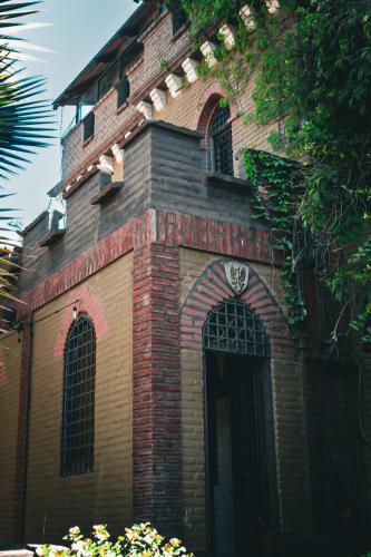 a red brick building with two windows and a door at Castillo Medieval in Viña del Mar