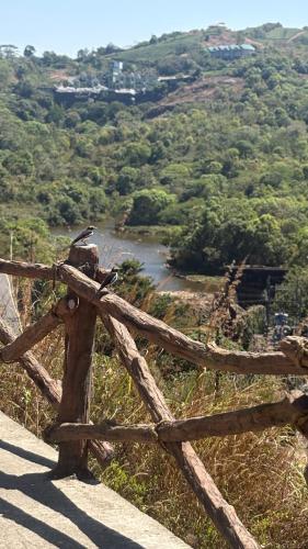 a wooden fence with a river in the background at Hill Monk - Bethany Heights in Vagamon