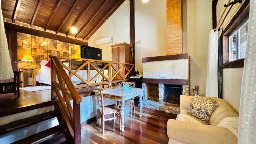 a living room with a couch and a fireplace at Estalagem Wiesbaden in Monte Verde