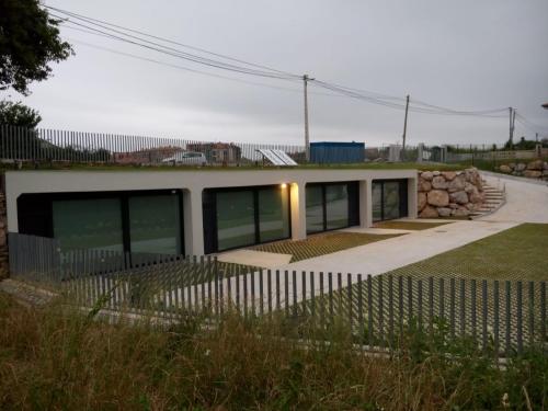 a house with a fence in front of it at Apartamentos EL SERRÓN Colombres in Colombres