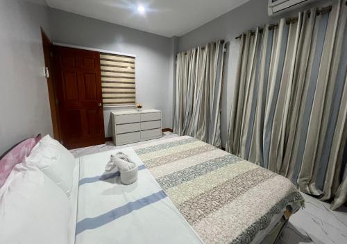a bedroom with a bed and a window at Mgf Franz Pension House in Bogo