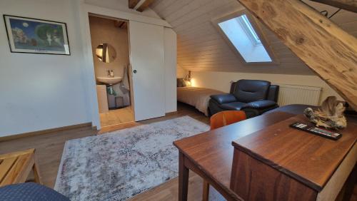 a living room with a couch and a table in a room at Maison 1902 in Tramelan