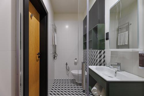 a bathroom with a sink and a toilet at TULIP Residences Lviv in Lviv