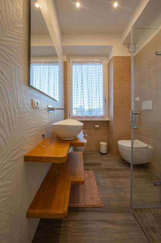 a bathroom with a sink and a bath tub at DomusBiri in Bracciano