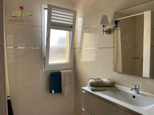 a bathroom with a sink and a mirror at Villa Bonita in Corralejo