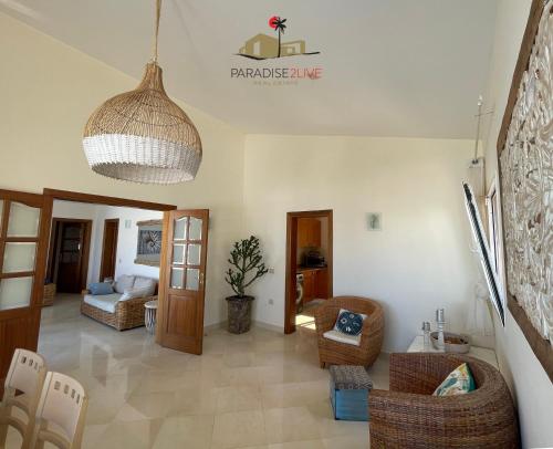 a living room with a couch and chairs and a ceiling at Villa Bonita in Corralejo