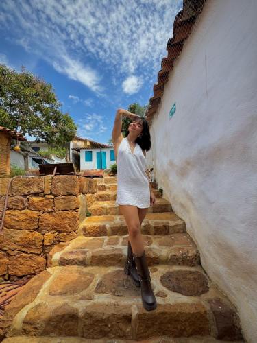 a woman is standing on some stairs at Habitación doble in Barichara