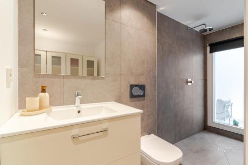 a bathroom with a sink and a toilet at La casa de la Abuela in Marbella