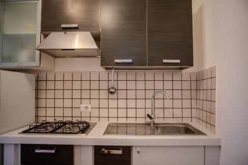 a kitchen with a sink and a stove at La Casa del Fico in Sezze