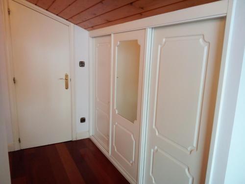 a hallway with a closet and a door at Mundaka Vista Mar L-BI-52 in Mundaka