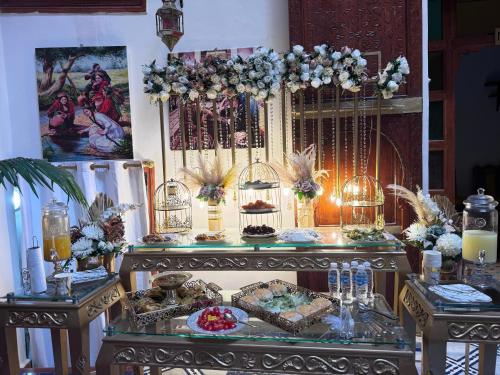 a table with a buffet with cakes and other foods at Riad Hamad Tijani in Fès