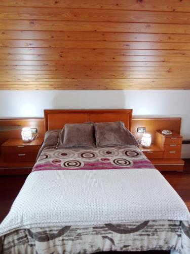 a bedroom with a large bed with wooden walls at Mundaka Vista Mar L-BI-52 in Mundaka