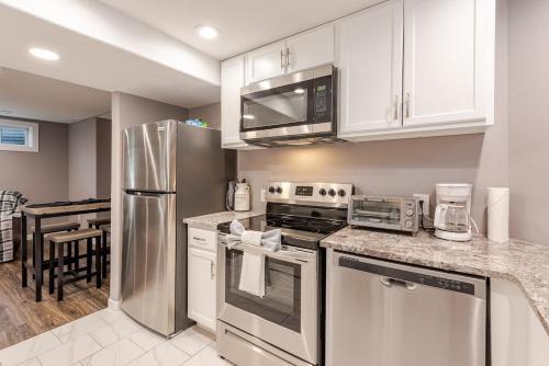 a kitchen with white cabinets and stainless steel appliances at Cottonwood Loveland in Loveland