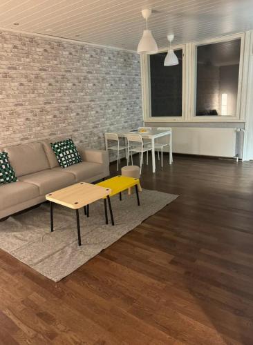 a living room with a couch and tables in it at Warm and cozy house in Rovaniemi