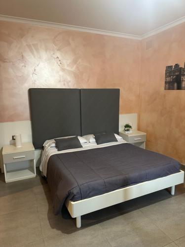 a bedroom with a large bed and two night stands at Sabrina Airport in Fiumicino