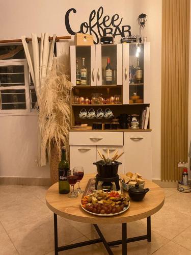 a table with a plate of food and glasses of wine at Cabernet Cabaña - La Cava Lodge in Medellín