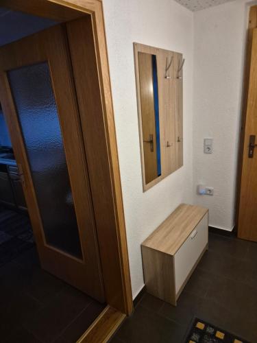 a room with a door and a drawer and a mirror at Ferienwohnung Selb in Selb