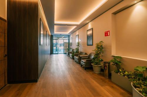 an office corridor with couches and potted plants at Canada Central & Rooftop in Mexico City