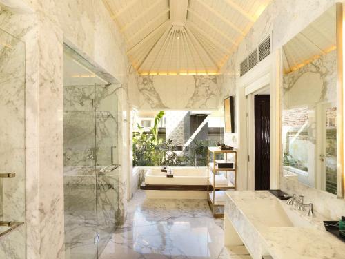 a bathroom with a tub and a sink at Sofitel Bali Nusa Dua Beach Resort in Nusa Dua