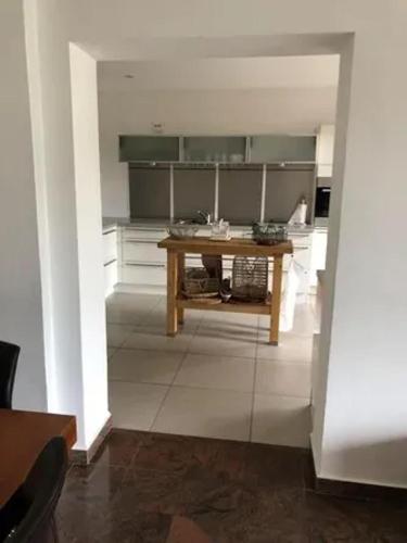 a kitchen with a table in the middle of a room at Villa spacieuse avec piscine à Rayol-Canadel-sur-Mer in Rayol-Canadel-sur-Mer