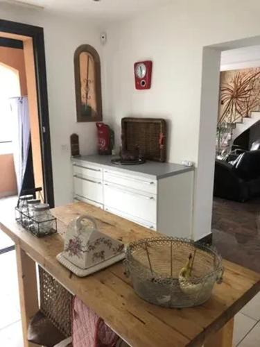 a kitchen with a table with a basket on it at Villa spacieuse avec piscine à Rayol-Canadel-sur-Mer in Rayol-Canadel-sur-Mer