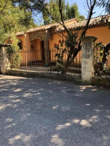 a house with a fence in front of it at Villa spacieuse avec piscine à Rayol-Canadel-sur-Mer in Rayol-Canadel-sur-Mer