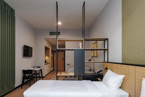 a bedroom with a bed and a table in a room at TULIP Residences Lviv in Lviv