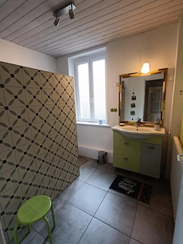 a bathroom with a sink and a mirror at Chambre d'hôte la Chanée in Saint-Germain-du-Bois
